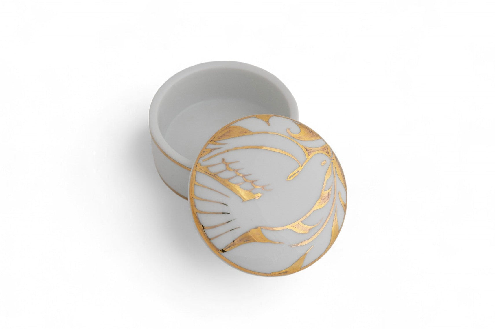 A small porcelain lidded box with gold banding and a gold bird of peace pattern on the lid.