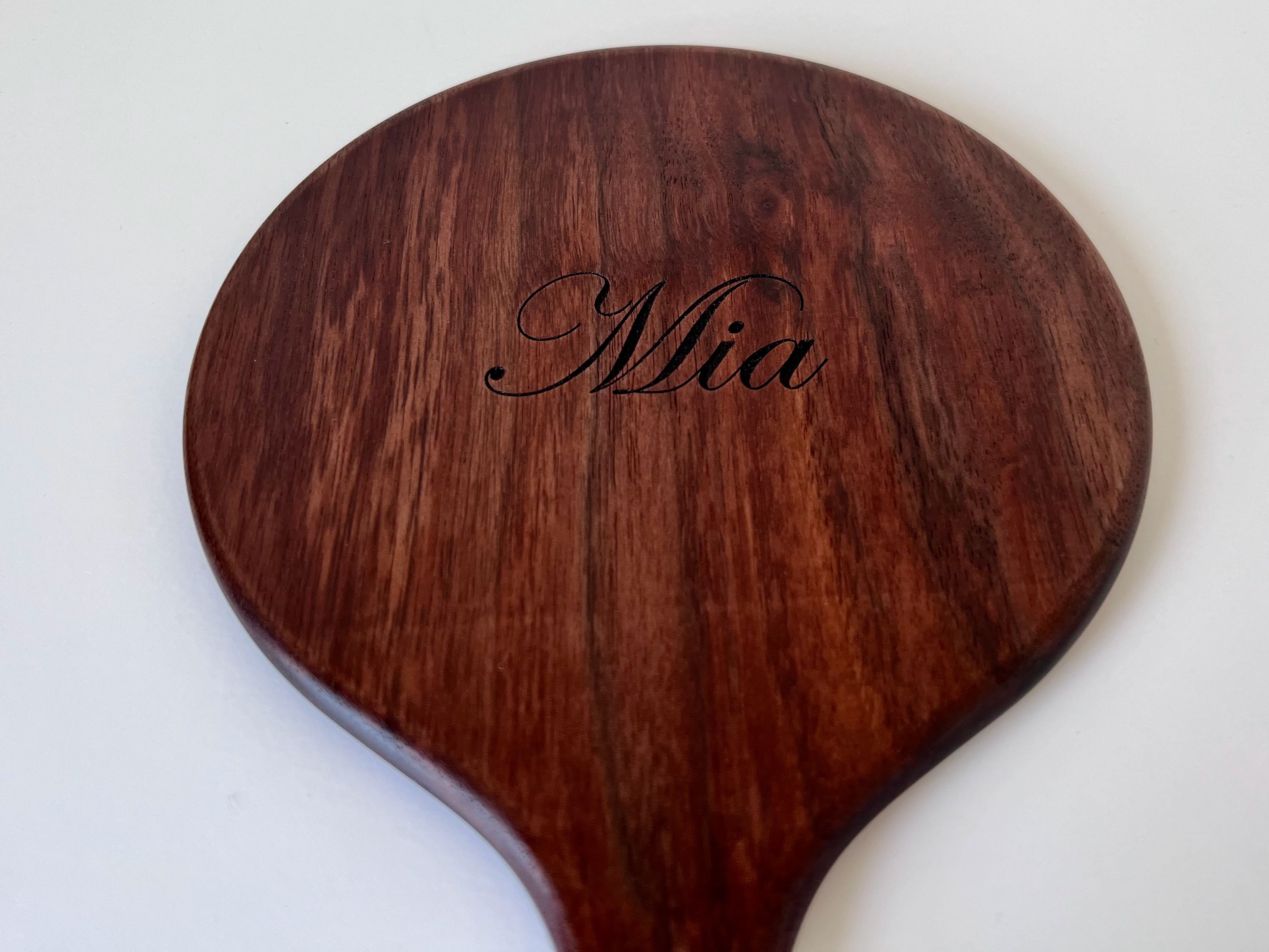 hand-carved mirror back with carved name "Mia"