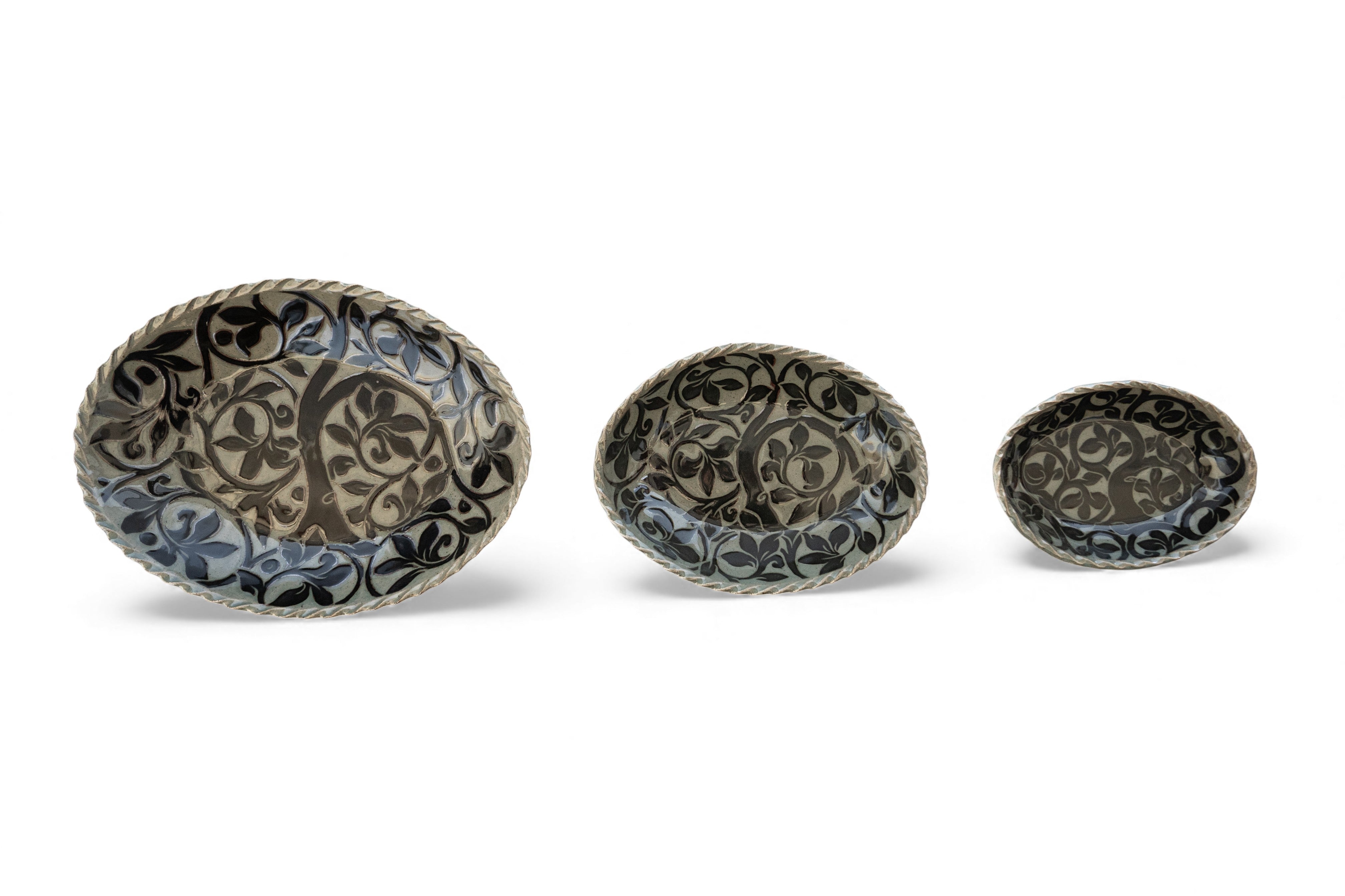 Handmade stoneware oval black carved platters with tree pattern
