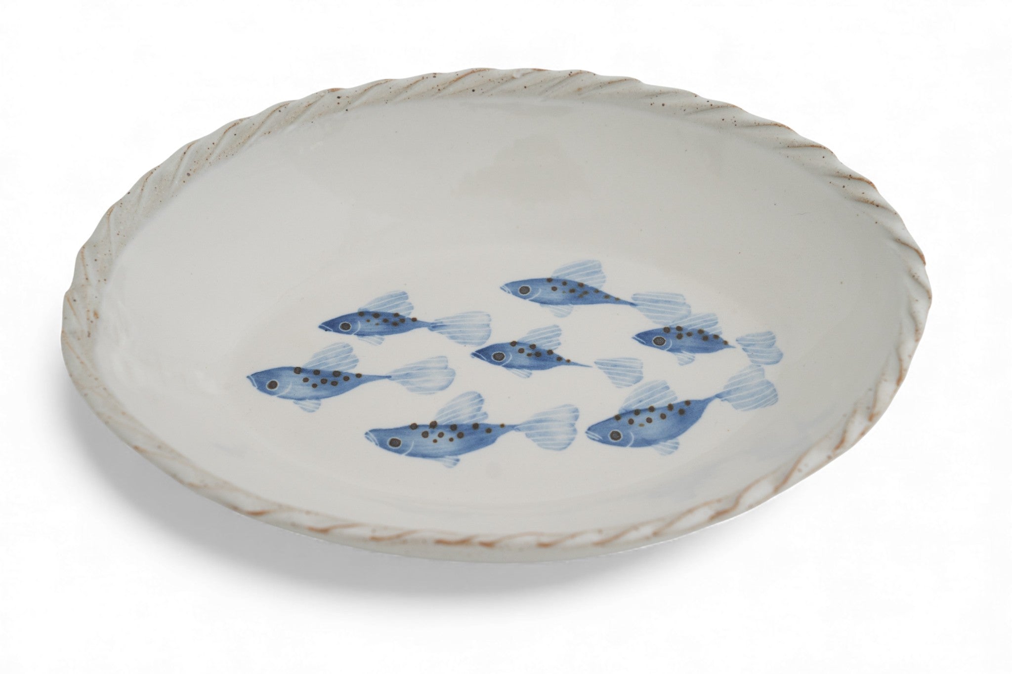 A handmade stoneware white oval platter with blue hand painted fish