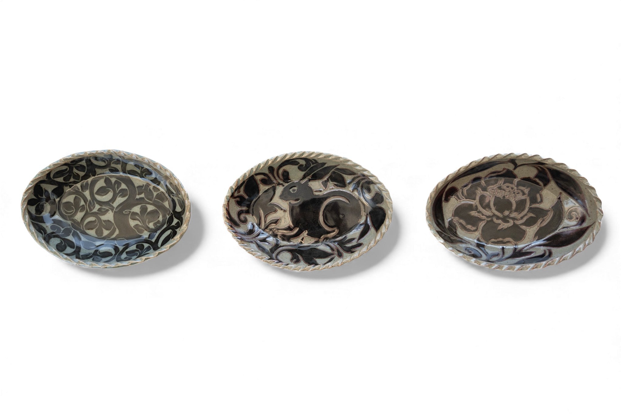 Handmade stoneware oval black carved platters with nature pattern