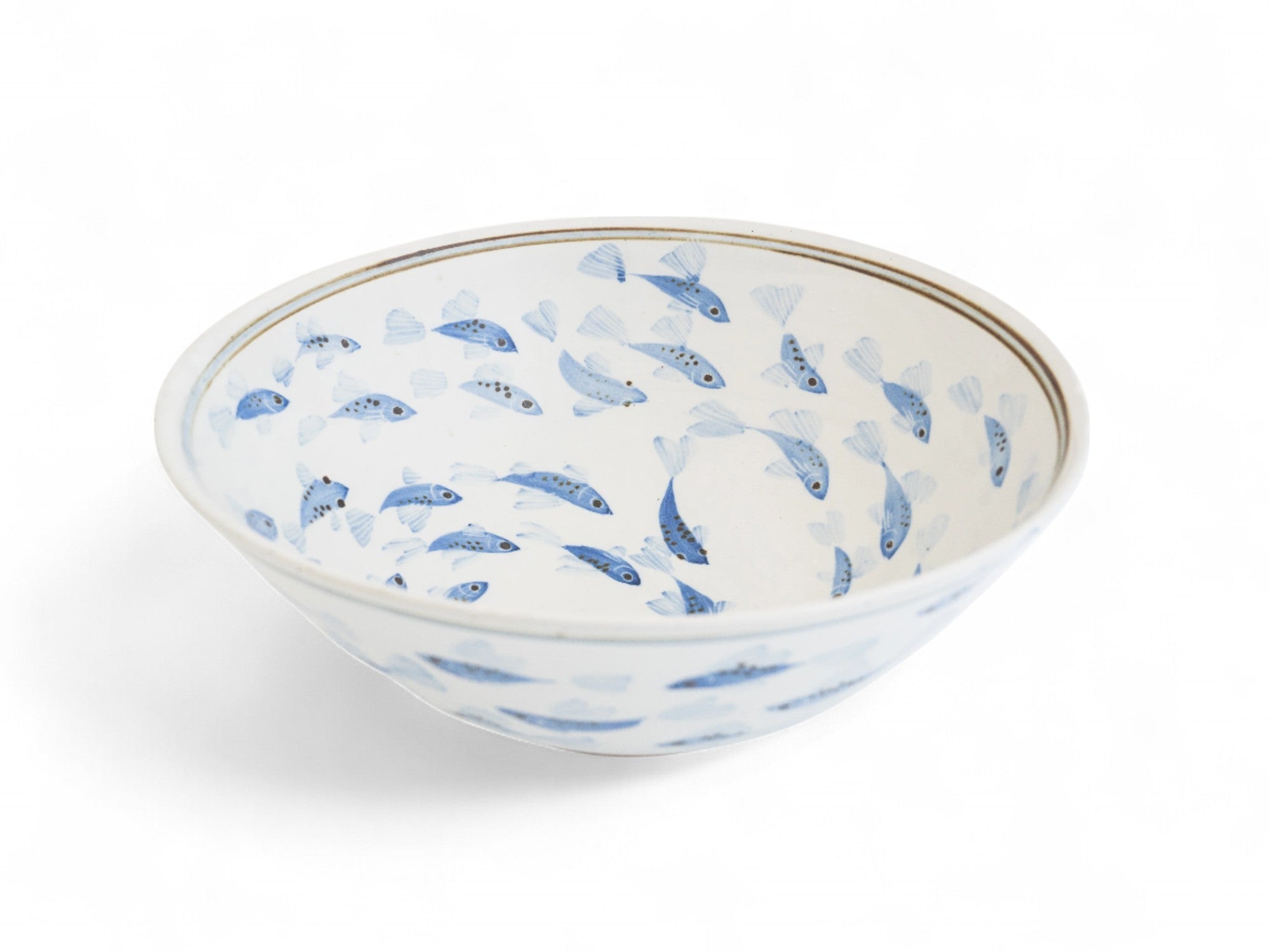 A hand-painted ceramic salad bowl with a blue fish pattern on a white background.