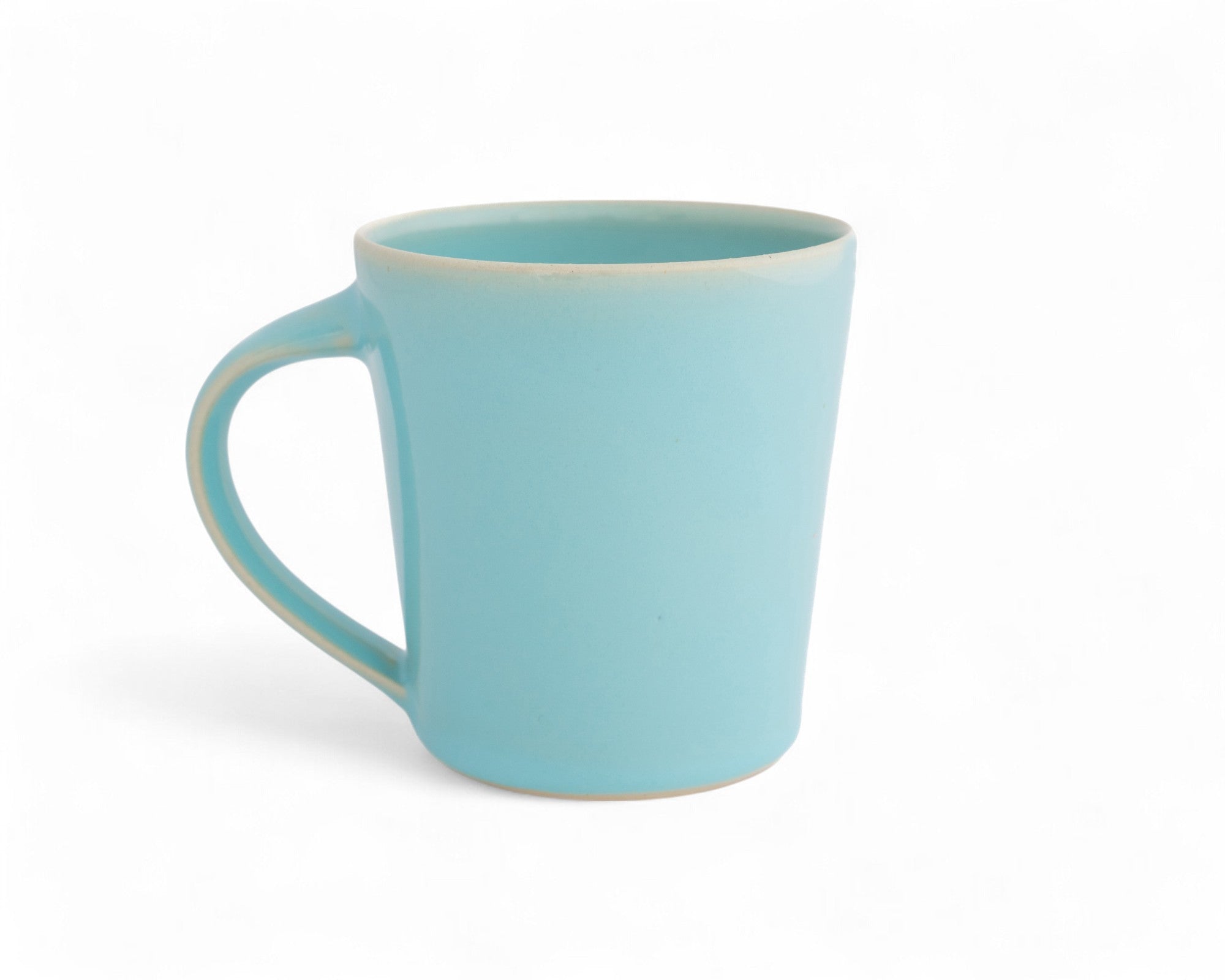 A hand-thrown blue ceramic mug with a glazed finish.