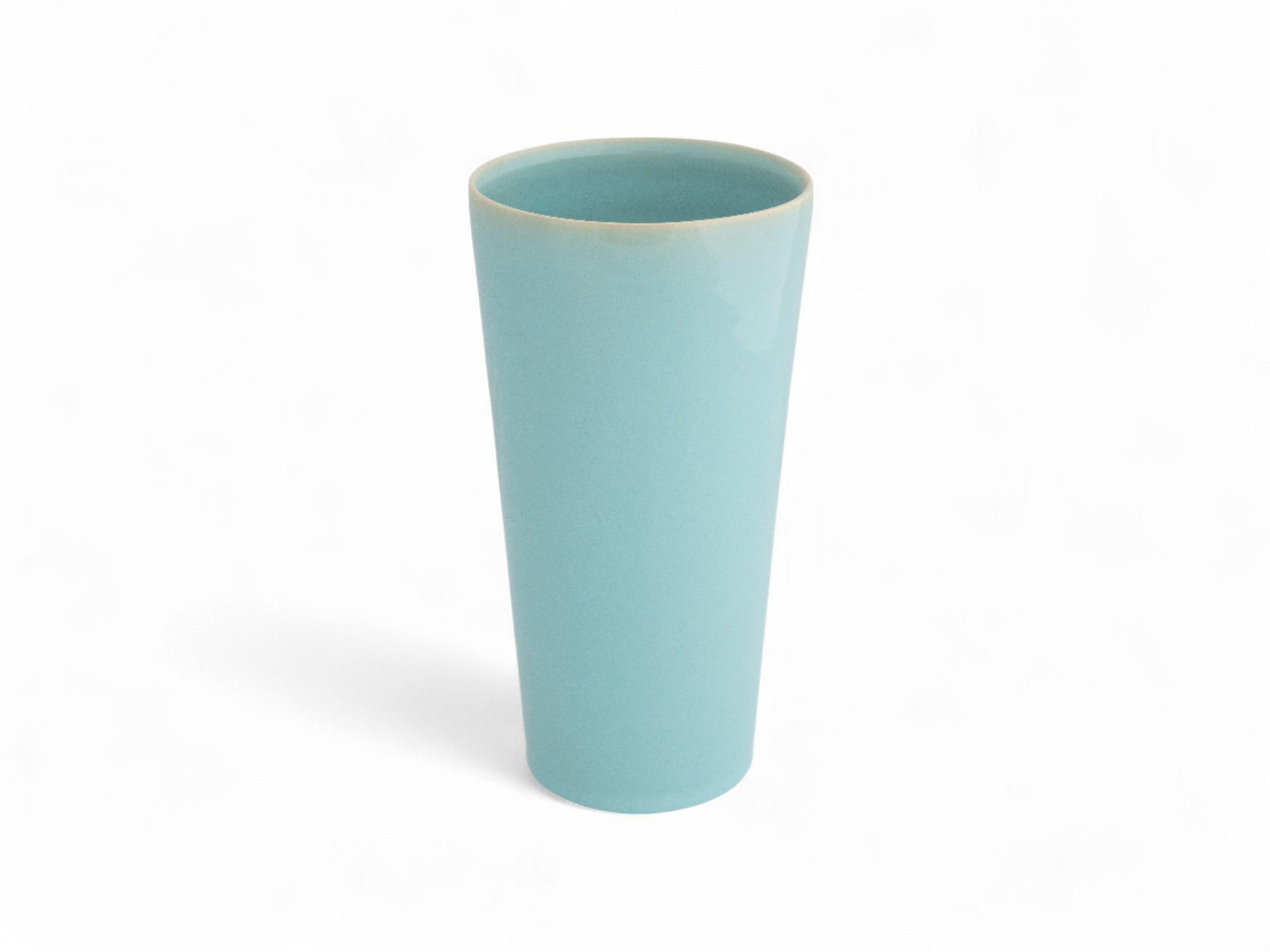 A hand-thrown, hand-dipped blue sky beaker stoneware vase with a glazed finish.