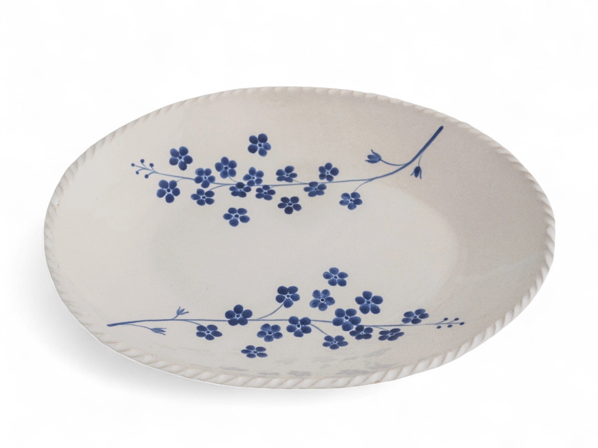 A large oval platter with a blue floral pattern on a white background.