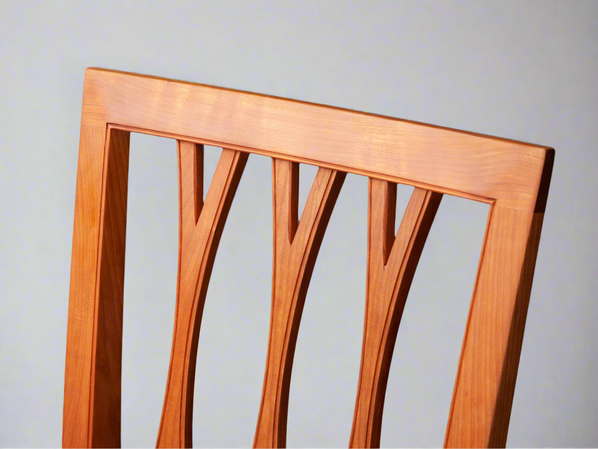 detail of fork-backed dining chair in cherry with bead