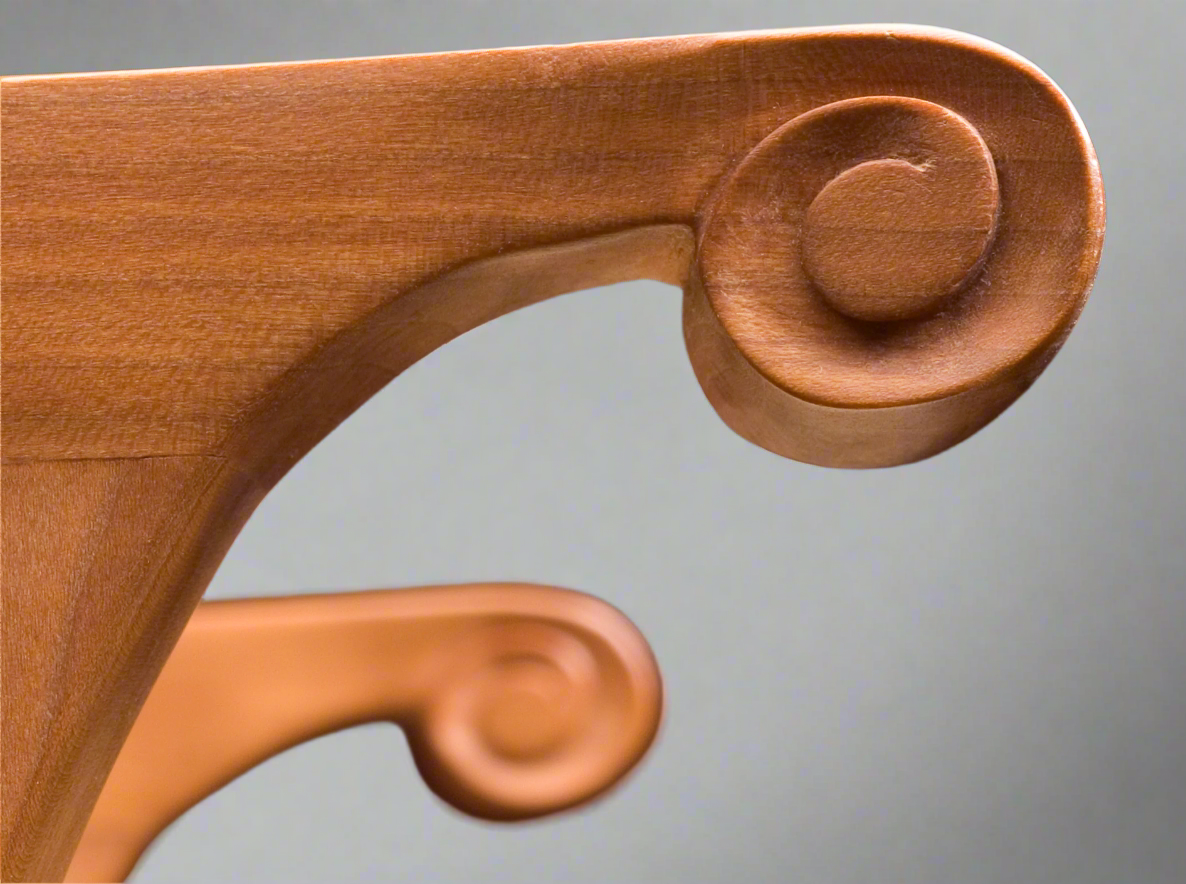 detail of hand carved curl on arm of chair
