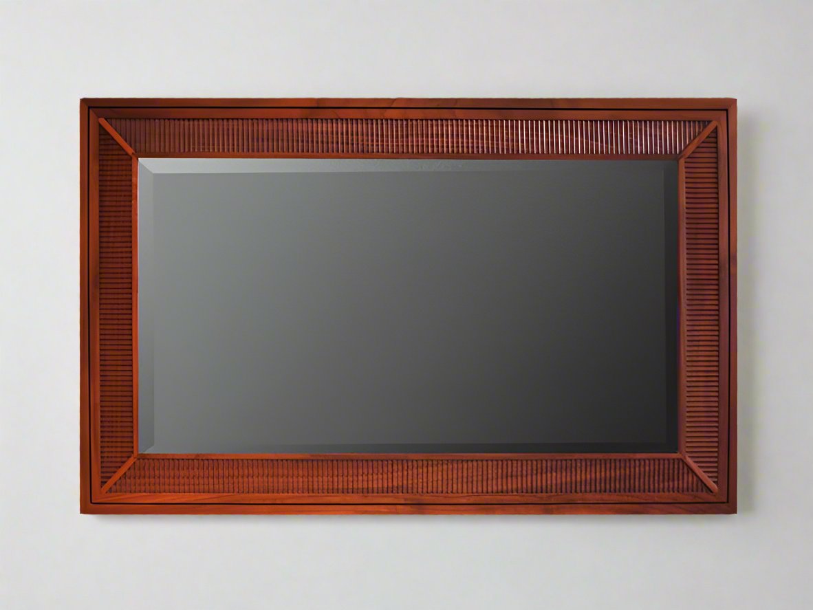 A modern classic mirror with beveled glass and fluted detailing, designed to be hung horizontally.