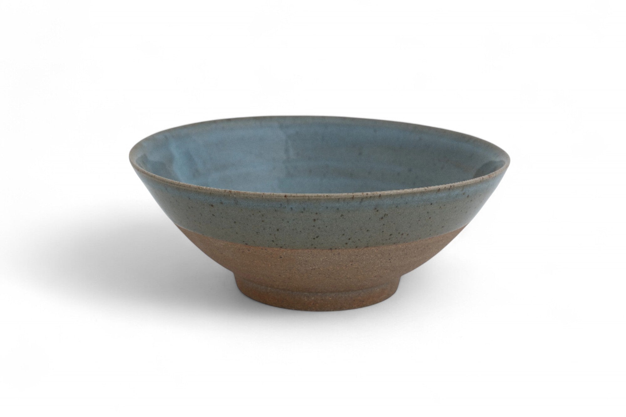 Handmade stoneware serving bowl with raw clay and celadon glaze