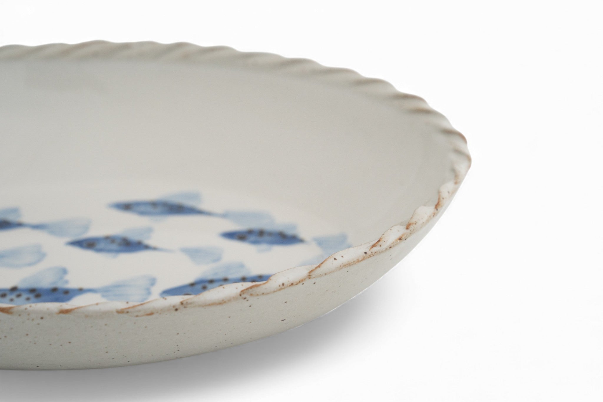 A handmade stoneware white oval platter with blue hand painted fish