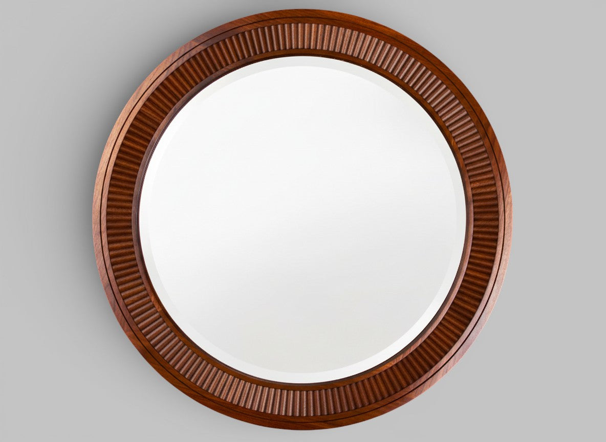 Round mirror with a wooden fluted frame.