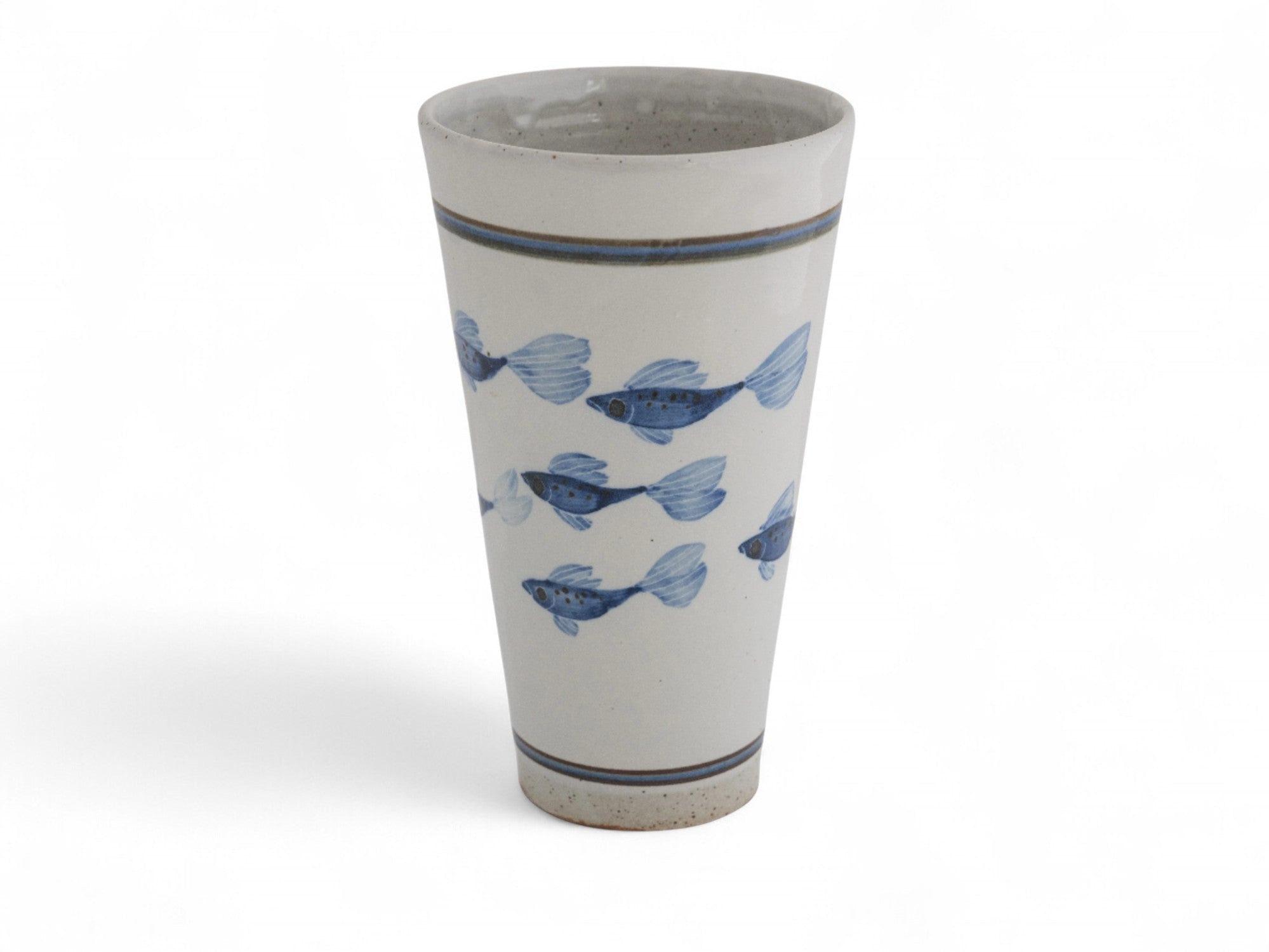 A hand-thrown stoneware beaker with blue painted fish pattern