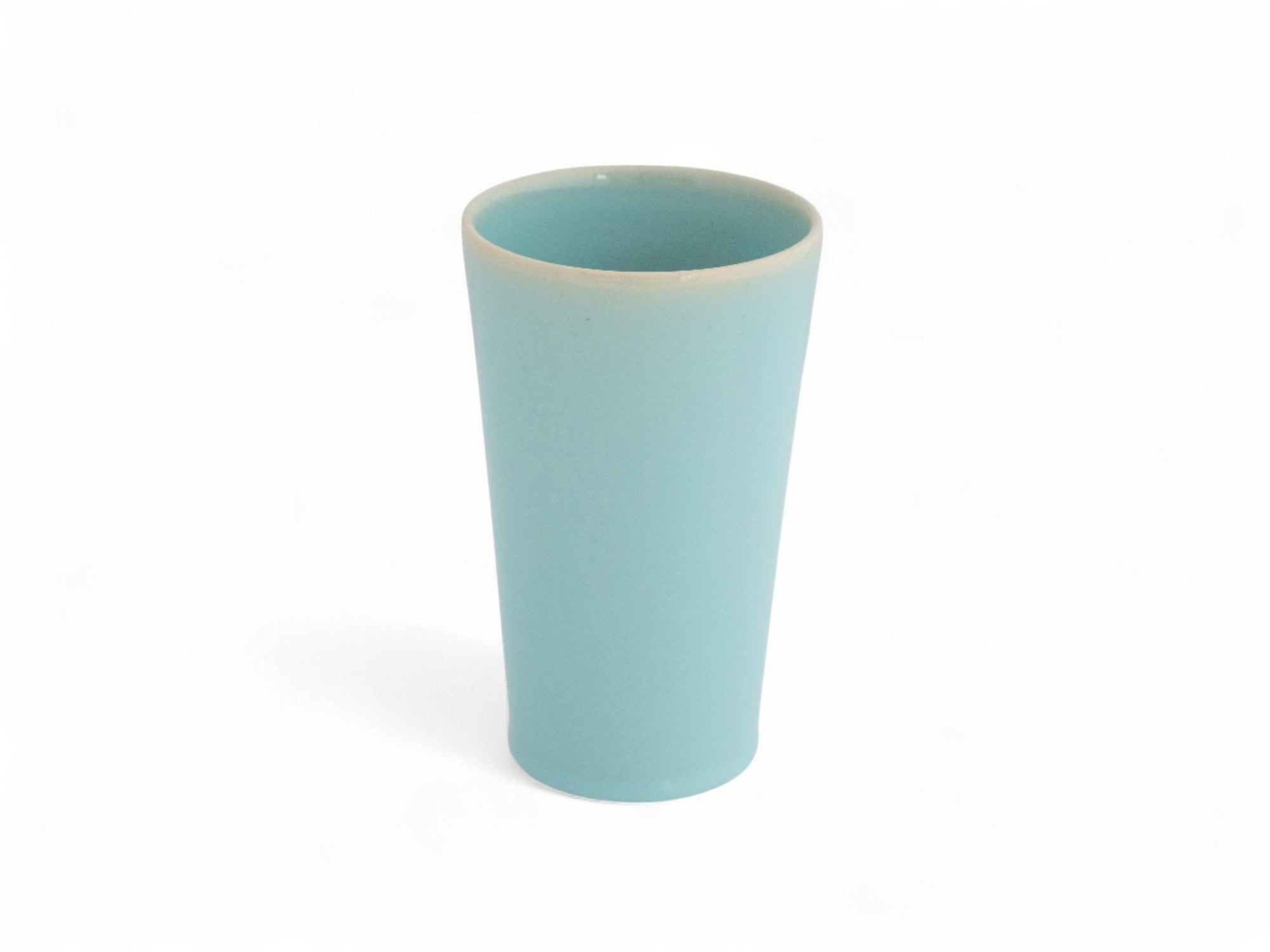 A hand-thrown, hand-dipped blue sky beaker stoneware vase with a glazed finish.