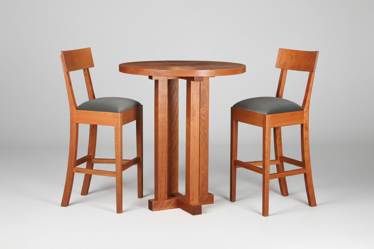 Handcrafted Ricardo Barstool in American Black Walnut featuring a steam-bent back, hand-planed wood surfaces, and a custom upholstered slip seat, made in Vermont.